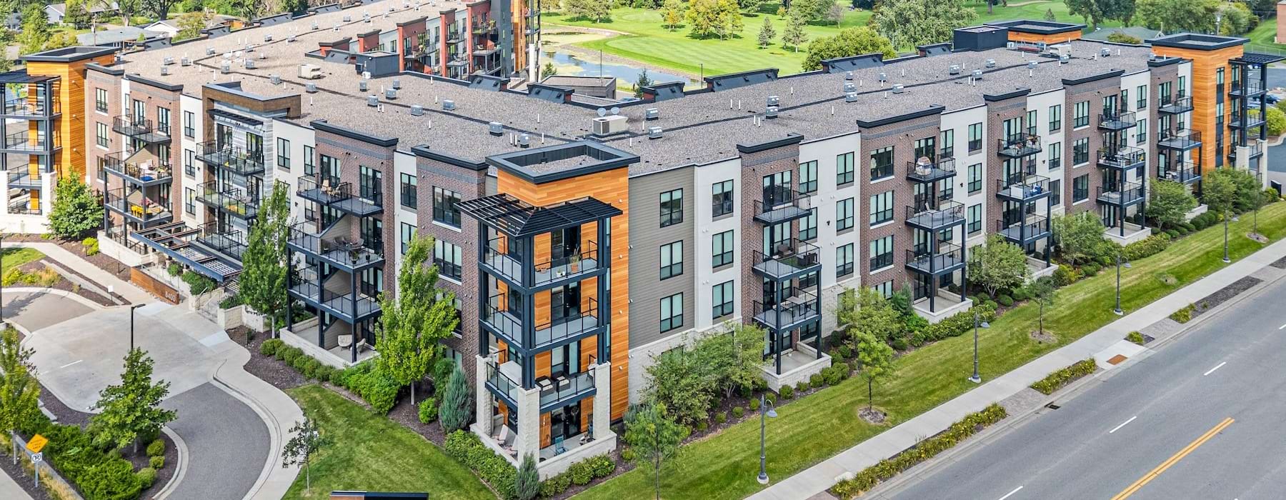 an aerial view of an apartment building with a road