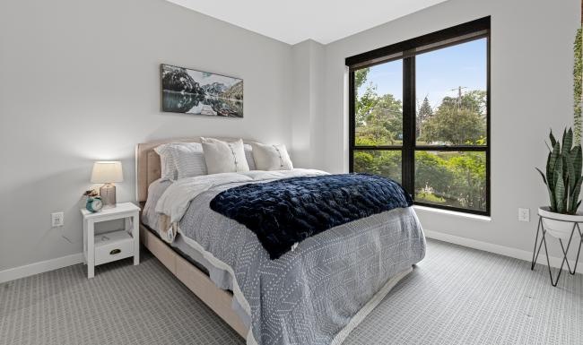 a bedroom with a bed and two nightstands